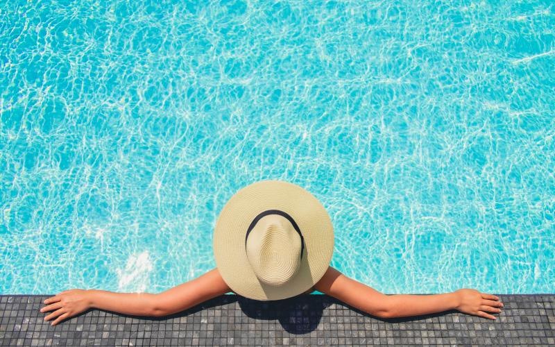 a woman resting on the edge of a pool