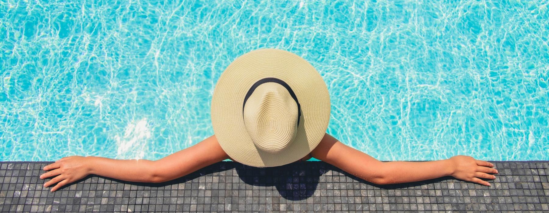 a woman resting on the edge of a pool